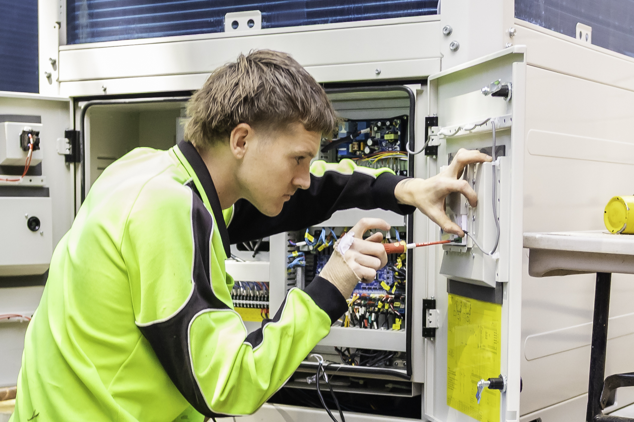 DCEA commercial electrician in Perth works on a control panel, delivering safe, efficient, and reliable electrical service