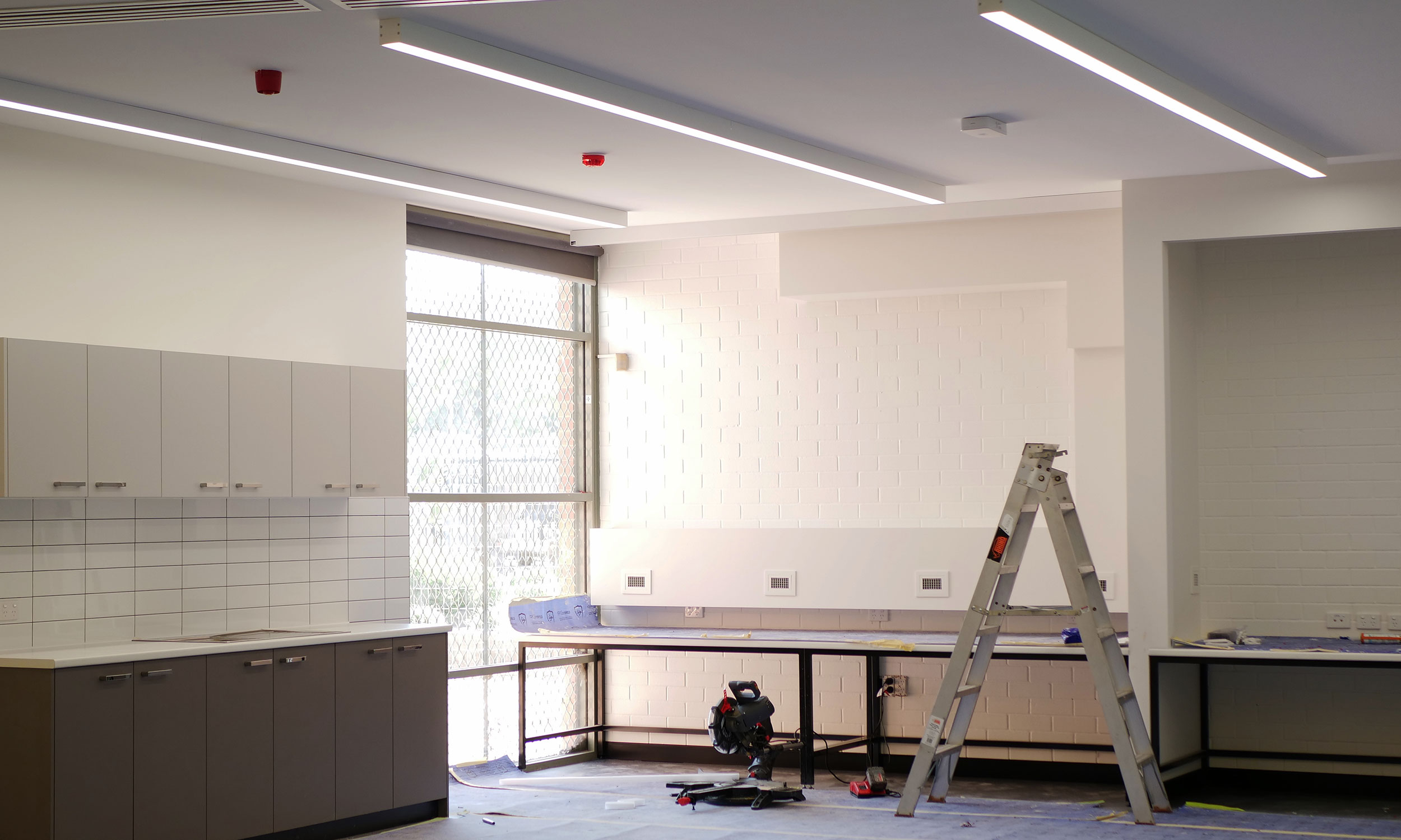 A room with a ladder leaning against the wall, indicating work by DCEA's strata electrician Perth