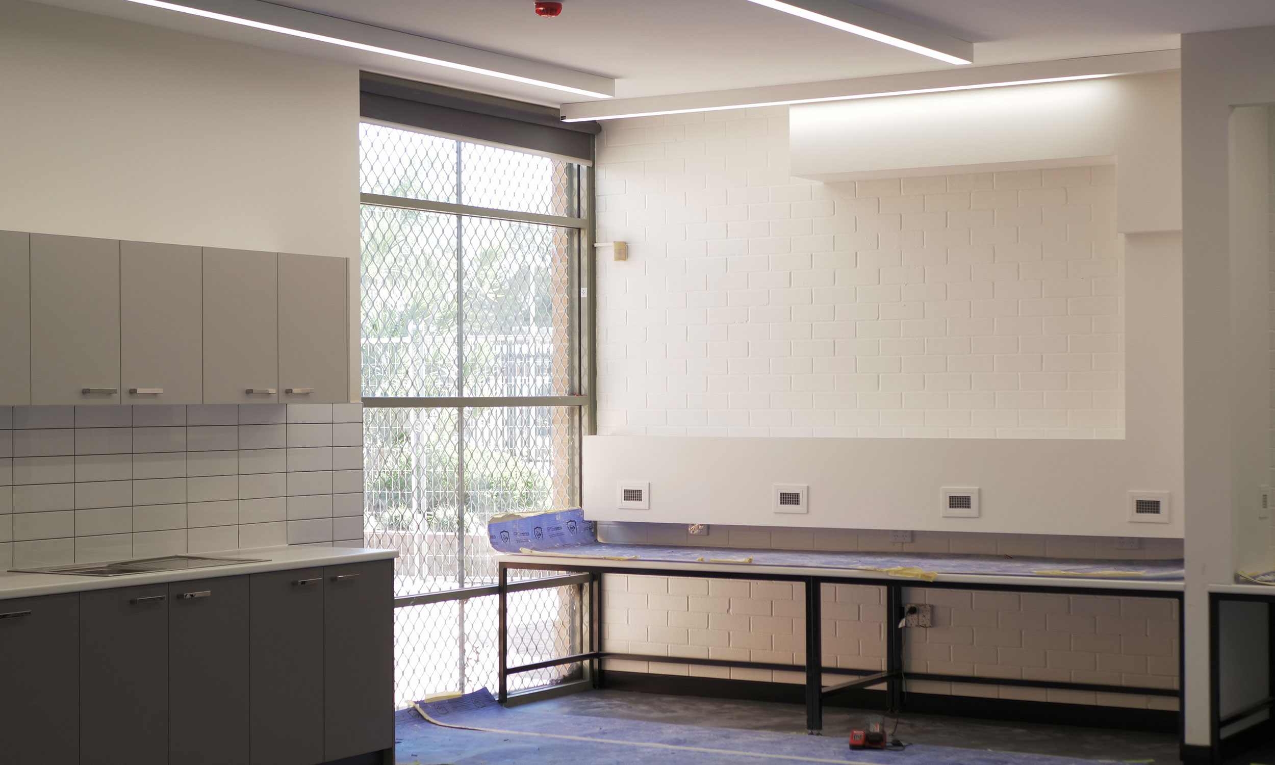 A room with a ladder leaning against the wall, indicating work by DCEA's strata electrician Perth
